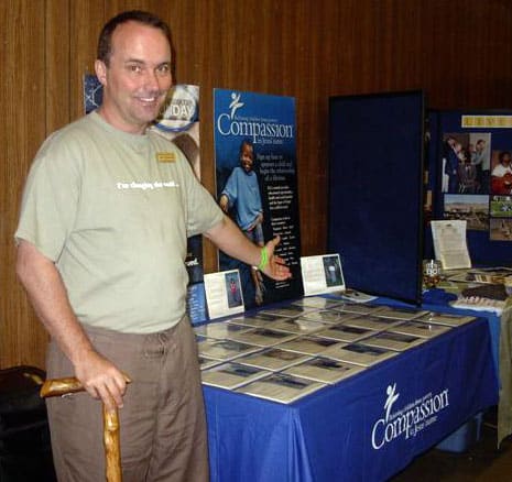Jeff shows off the Compassion table at Camp Winema's Week of Missions