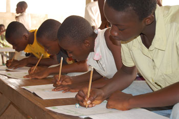 Children copying letters from their exercise books