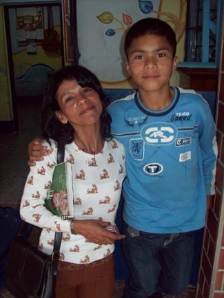 boy in blue shirt with arm around woman