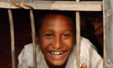 Sumonto at the window of his house