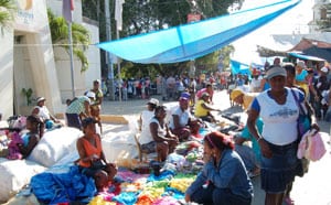 people selling items at a street market