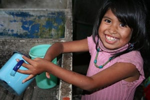 smiling girl washing dishes