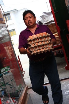 man carrying cartons of eggs