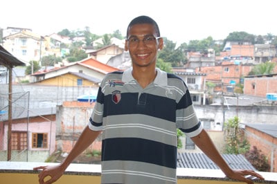 young man smiling with houses in the background