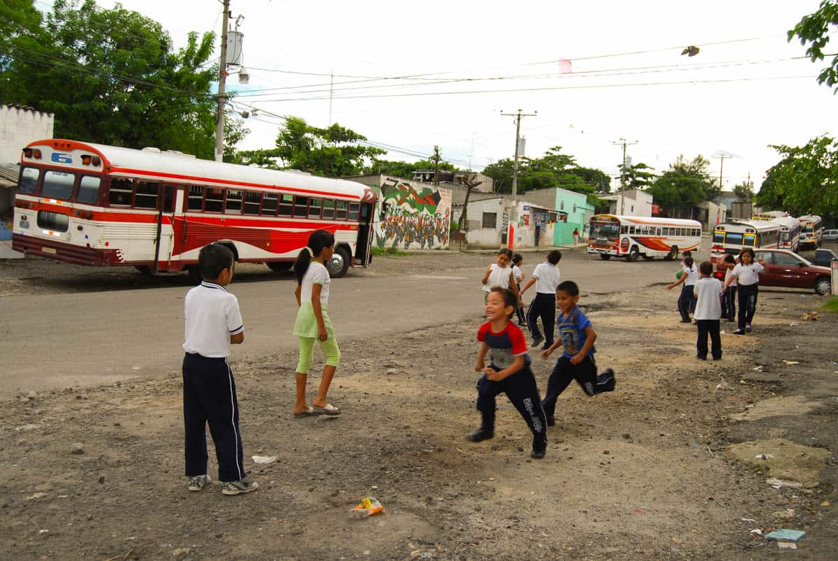 Children run on the streets of urban El Salvador