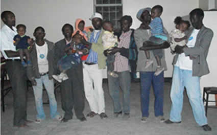 large gathering of men holding babies and small children