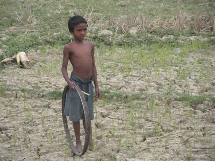 young boy holding a rolling hoop