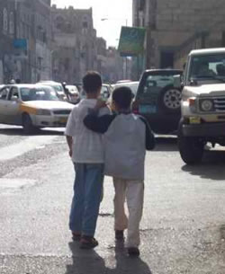 two children walking on busy road