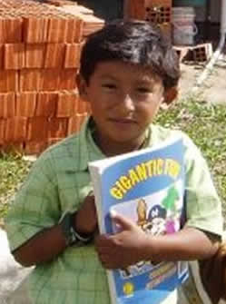 young boy holding a coloring book