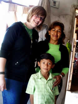 young woman standing next to a young boy and his mom