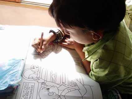 young boy coloring inside a coloring book