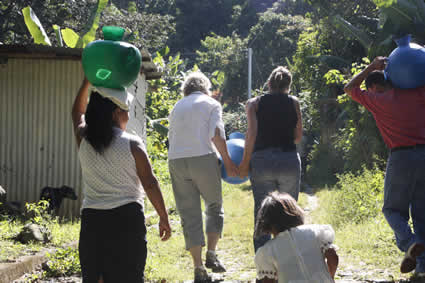 people carrying water jugs