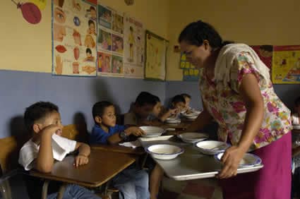woman serving children a meal