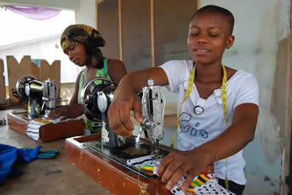 Ghanaian girl using sewing maching