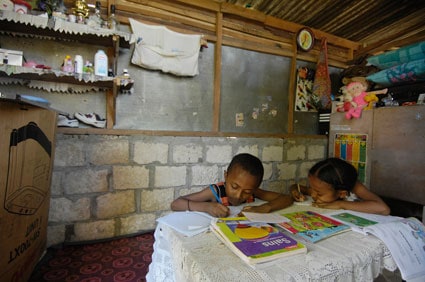 two children at a table inside a home