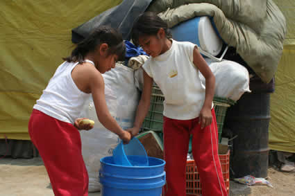 two children retrieving water