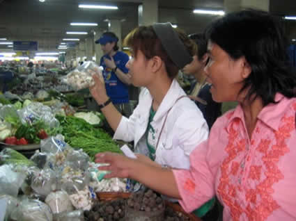 two women selling wares at a market
