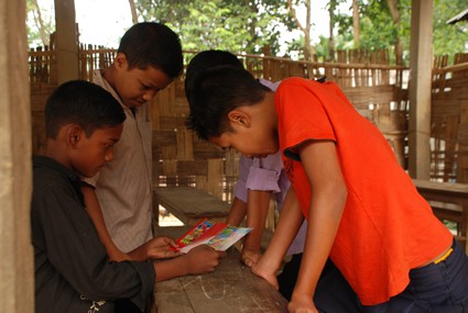 four boys reading letters