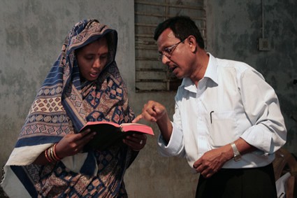 man and woman looking at open Bible