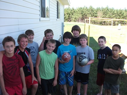 several boys holding soccer balls