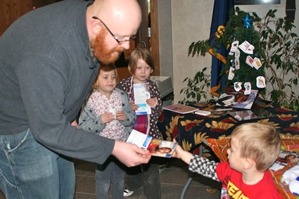 man handing pamphlets to some children