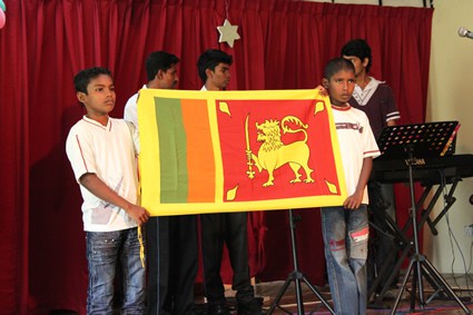 boys on stage holding a flag