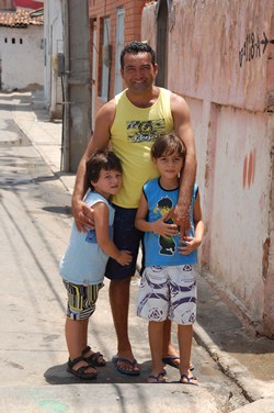 man standing between two children