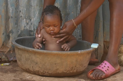 baby being washed in a tub