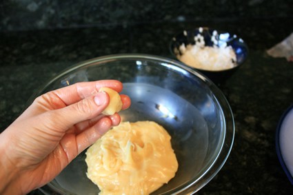 person making small balls of batter