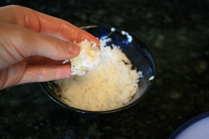 balls of batter coated in coconut flakes