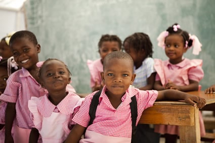 group of young girls and boys their red and white school clothes in Haiti