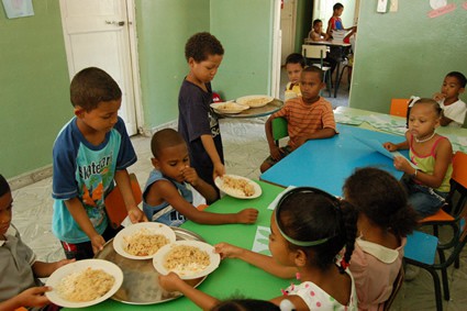 Small children being served a meal.