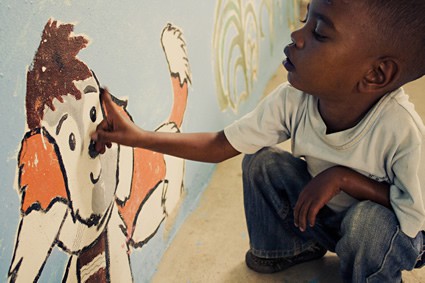 young boy looking at mural of dog on a wall