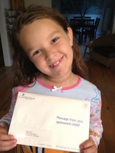 young girl holding envelope