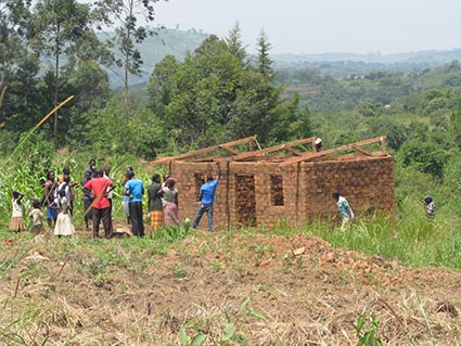 A group of people standing in front of a house being built