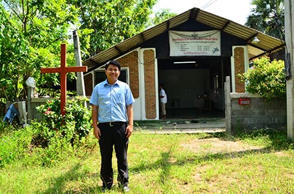 man standing in front of church in Thailand