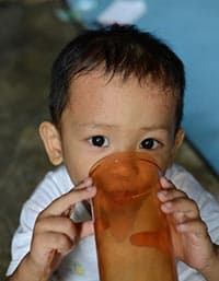 boy drinking from plastic cup