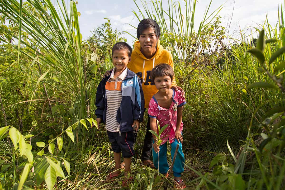 Natapong, who is enrolled at the CDC, and his family show off a healthy tea plant still too young to start picking. These plants should be ready for their first harvest late 2016.