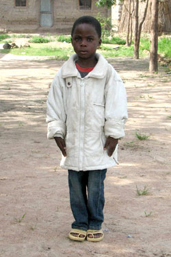young boy in white jacket
