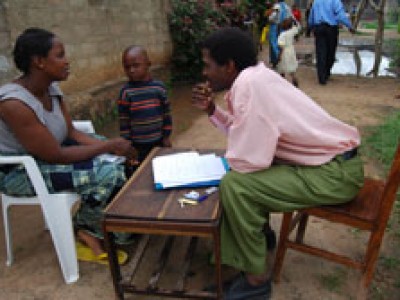 man and woman sitting at table and talking outdoors