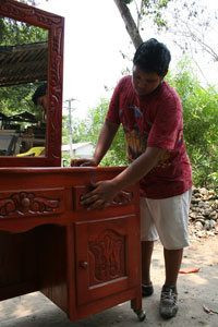 boy with wood carved dresser