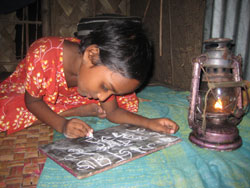 young child writing on a chalkboard