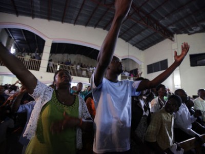 group of people worshiping with raised hands