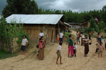 group of people standing outside of a house