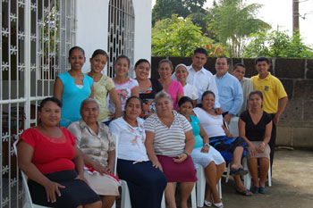 group of men and women posing for photo