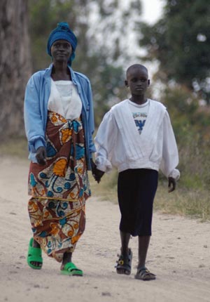 woman and child walking and holding hands