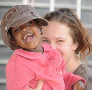 girl holding smiling child