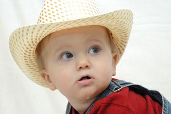 little boy wearing a cowboy hat
