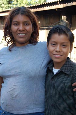 woman with arm around boy's shoulder