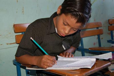 boy writing at desk